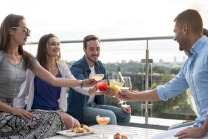 An Urban Oasis with Expansive Views - friends toasting at a party